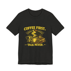 Old Man Snark black cotton t-shirt with yellow text "COFFEE FIRST. TALK NEVER." and coffee-themed graphic.