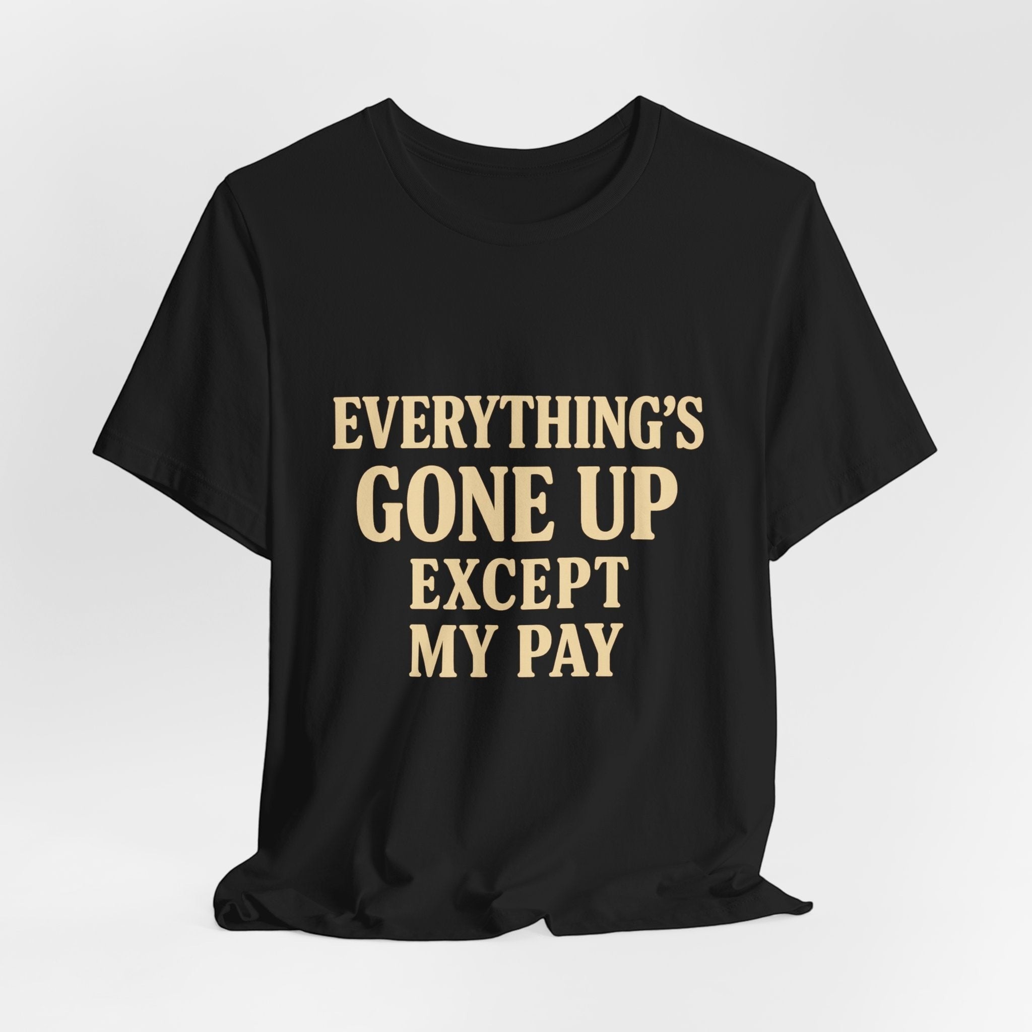 The "Everything's Gone Up Except My Pay" T-Shirt by Printify features bold beige lettering on black Airlume cotton—perfect for making a statement about rising living costs.