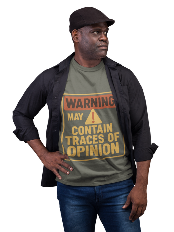 Man wearing Opinion Warning Tee with humorous text warning about opinions, styled with black shirt and cap.