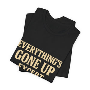 A folded black Airlume cotton "Everything's Gone Up Except My Pay" T-Shirt by Printify (Old Man Snark), featuring bold beige text—a witty nod to rising living costs.