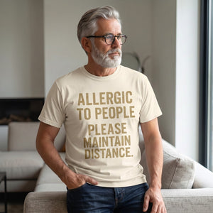 Old Man Snark cream heavyweight cotton t-shirt with Allergic to People slogan worn by a man with a grey beard.