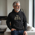 Old Man Snark black midweight fleece hoodie with Not Exactly Shocking slogan worn by a mature man with grey hair.