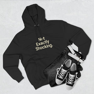 Old Man Snark black midweight fleece hoodie with Not Exactly Shocking slogan, styled with dark jeans and sneakers.