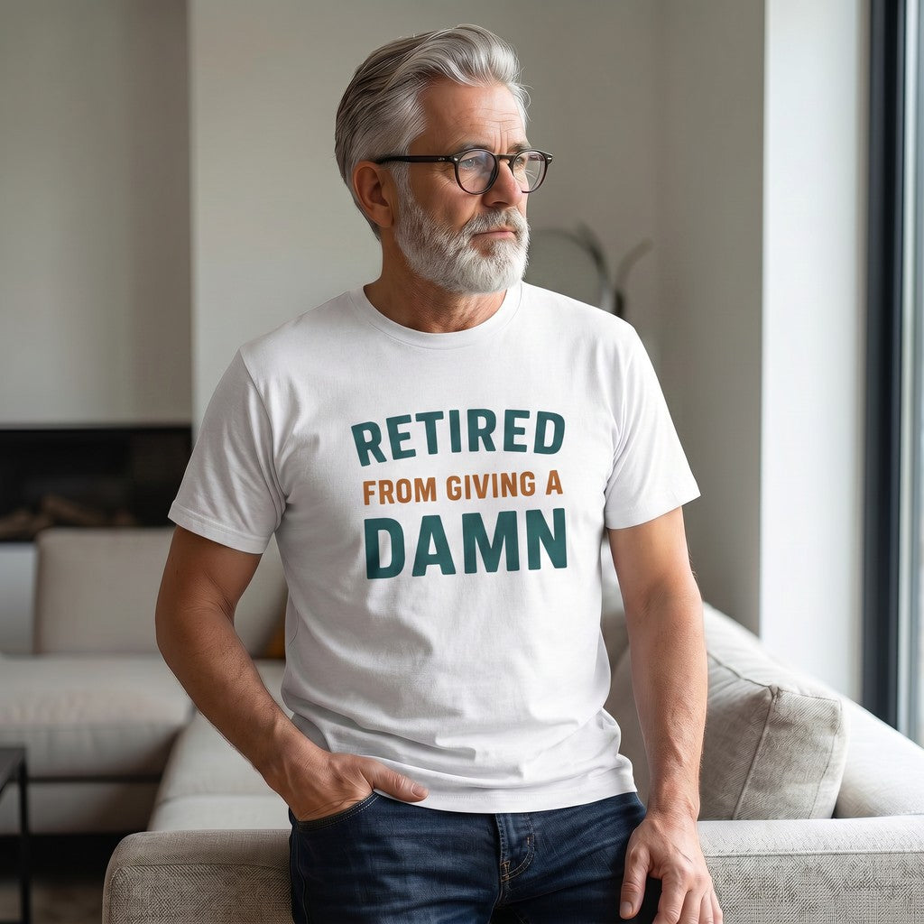 Old Man Snark white cotton t-shirt with Retired From Giving A Damn text worn by a man with grey hair and glasses.
