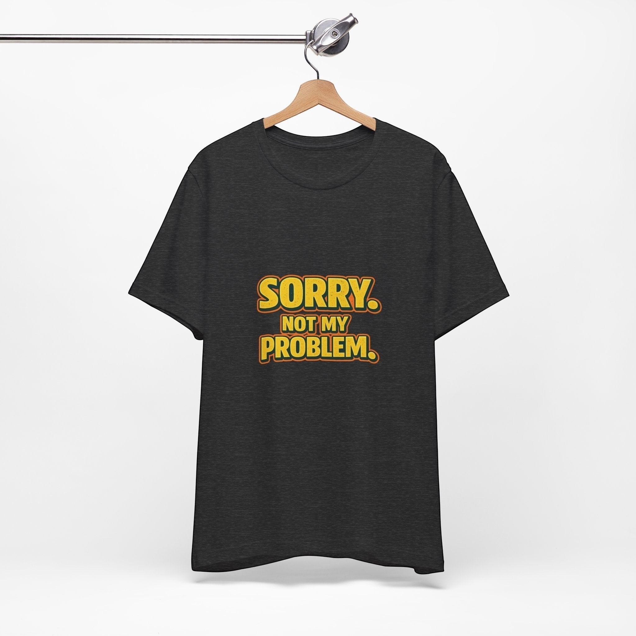 Old Man Snark black cotton t-shirt with retro gold and orange Sorry. Not My Problem. text on a wooden hanger.