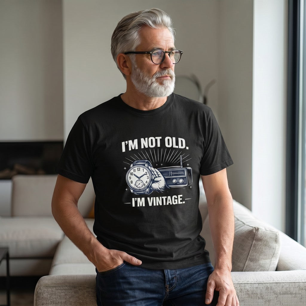 Old Man Snark black cotton t-shirt with I'm Not Old I'm Vintage slogan, worn by a man with grey hair and glasses.