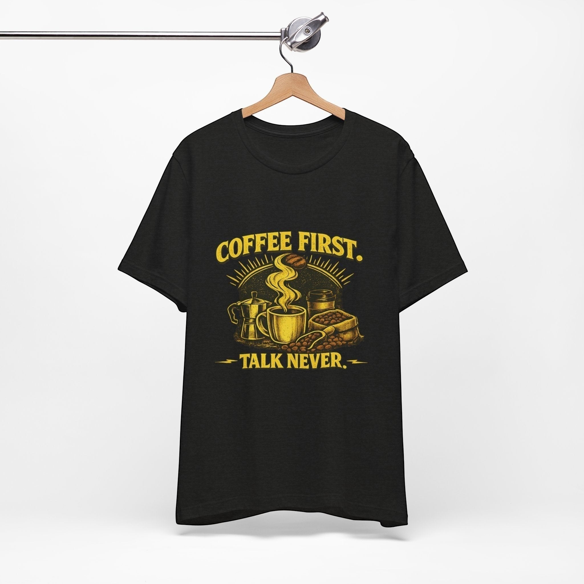 Old Man Snark black cotton t-shirt with yellow "COFFEE FIRST. TALK NEVER." graphic featuring a coffee cup, moka pot, and coffee beans.