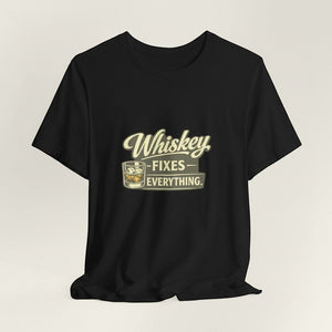 The "Whiskey Fixes Everything" T-Shirt by Printify features a whiskey glass graphic and retro cream-and-yellow lettering—perfect for whiskey lovers or as a men’s gift.