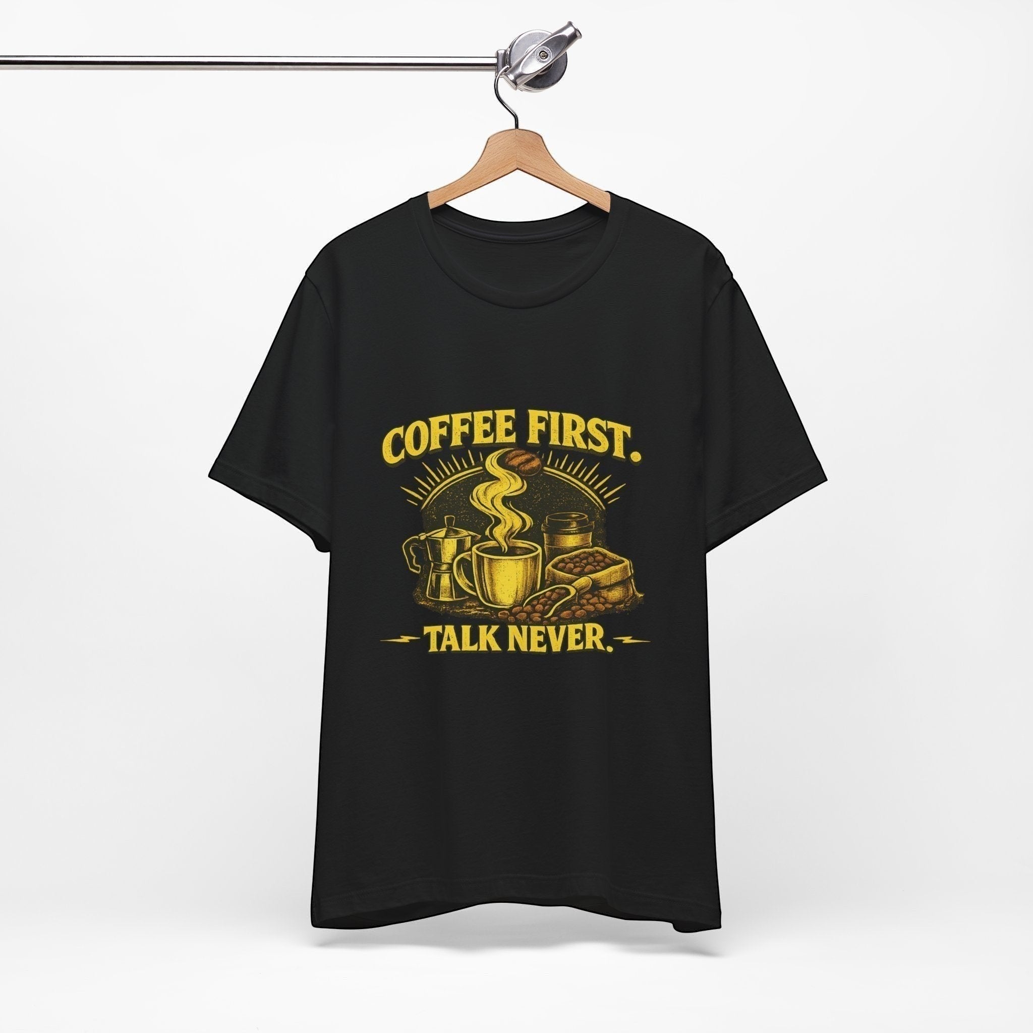 Old Man Snark black cotton t-shirt with yellow "COFFEE FIRST. TALK NEVER." graphic featuring a steaming mug, moka pot, and coffee beans.