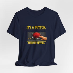 The "It's A Button. Push The Button." T-Shirt by Old Man Snark from Printify features soft Airlume cotton, a finger pressing a large red button, and playful tech support text—perfect for any IT enthusiast.