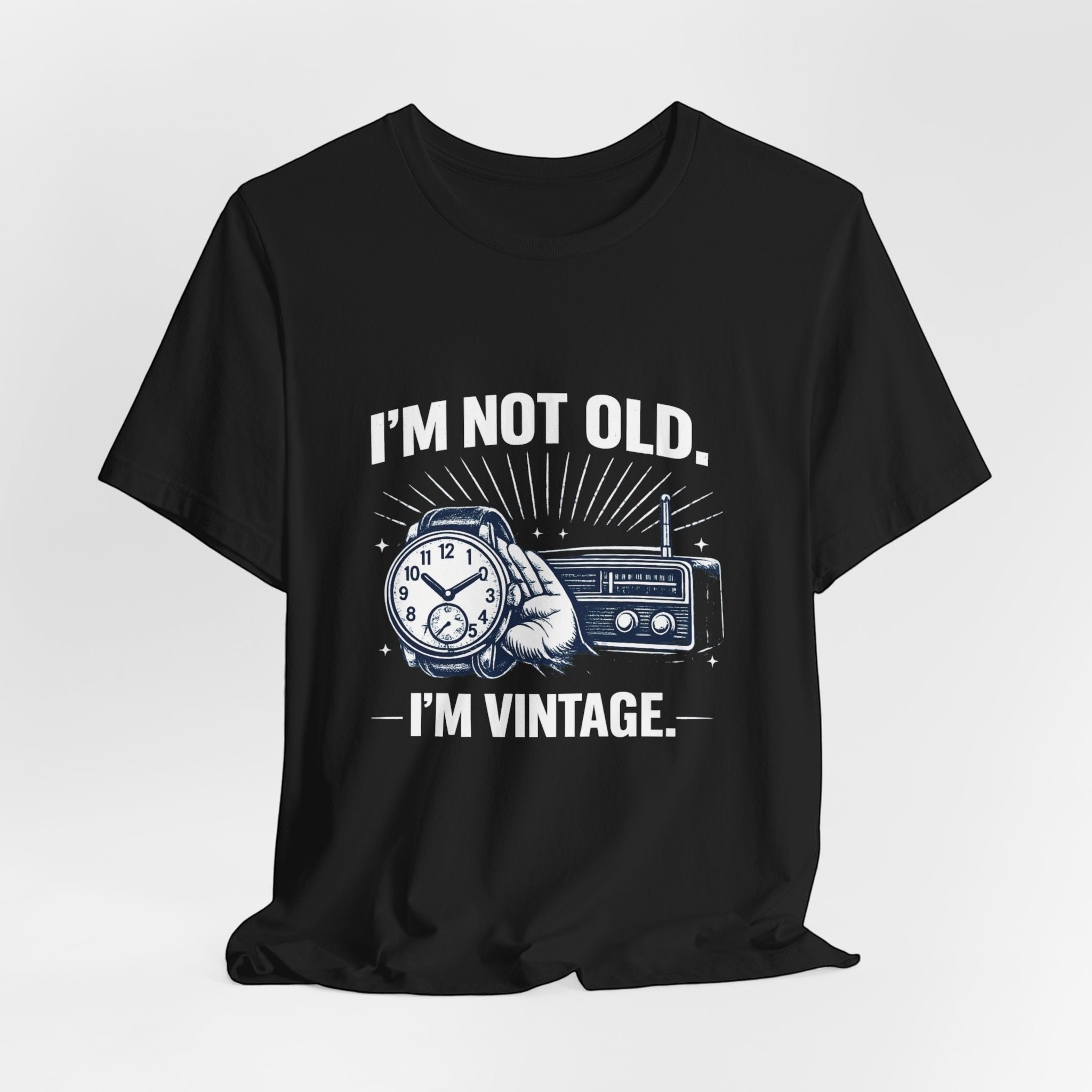Old Man Snark black cotton t-shirt with "I'm Not Old, I'm Vintage" graphic featuring a hand holding a watch and a vintage radio.