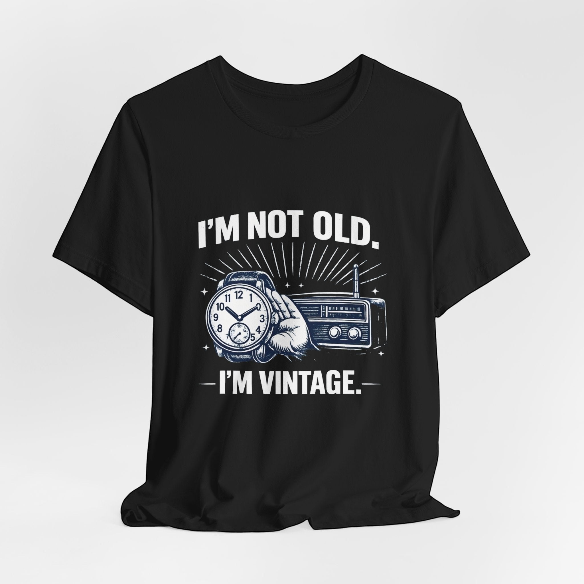 Old Man Snark black cotton t-shirt with "I'm Not Old, I'm Vintage" graphic featuring a hand holding a watch and a vintage radio.